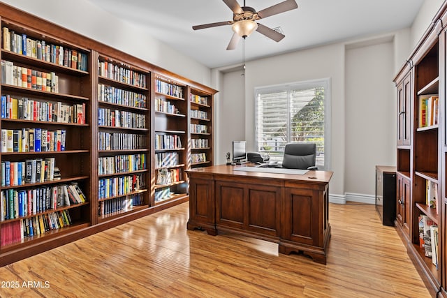 office area with light hardwood / wood-style flooring and ceiling fan