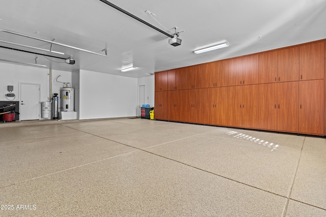 garage featuring a garage door opener and water heater