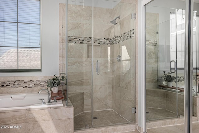 full bathroom with a bath and a stall shower