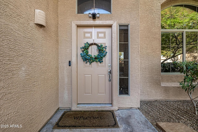 property entrance with stucco siding