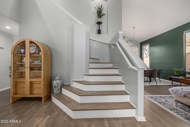 stairs with baseboards and wood finished floors