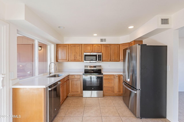 kitchen featuring light tile patterned floors, sink, and appliances with stainless steel finishes