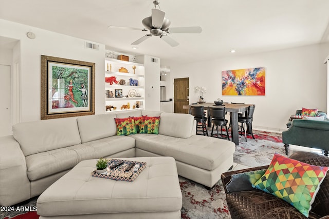 living area with visible vents and a ceiling fan