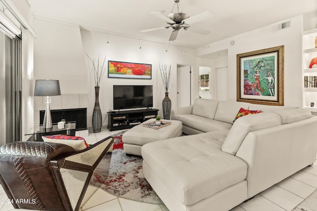 living area with light tile patterned floors, visible vents, and a ceiling fan