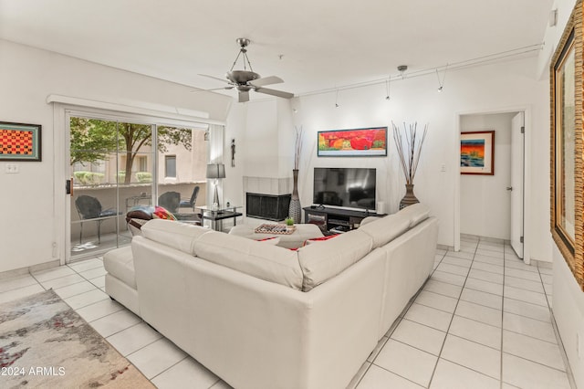 living area with light tile patterned flooring and ceiling fan