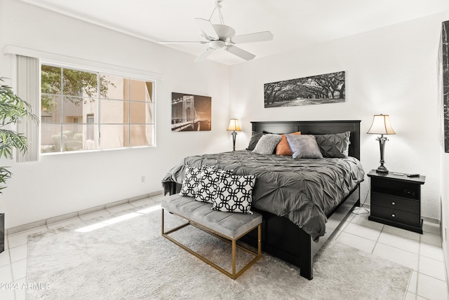 tiled bedroom with a ceiling fan