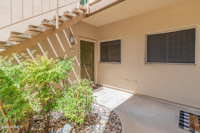 property entrance featuring stucco siding