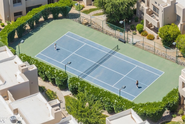 view of tennis court featuring fence