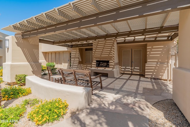 view of patio featuring an outdoor fireplace and a pergola