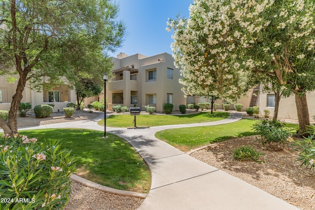 view of home's community featuring a lawn