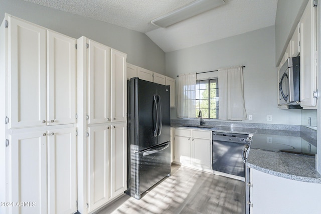 kitchen with sink, white cabinets, and black appliances