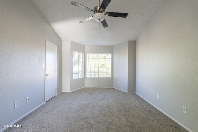 carpeted empty room featuring a textured ceiling and ceiling fan