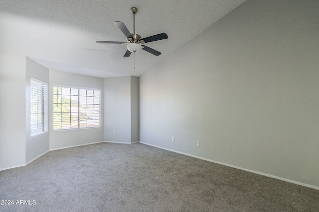 carpeted empty room featuring ceiling fan and vaulted ceiling