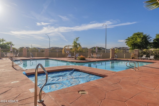 view of pool featuring a patio area and a community hot tub