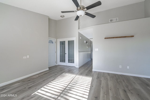 unfurnished room featuring ceiling fan, light hardwood / wood-style floors, and french doors