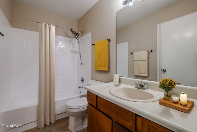 full bathroom with shower / tub combo, hardwood / wood-style floors, vanity, and toilet