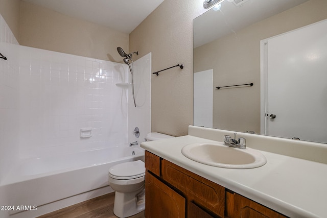 full bathroom featuring hardwood / wood-style flooring, vanity, bathing tub / shower combination, and toilet