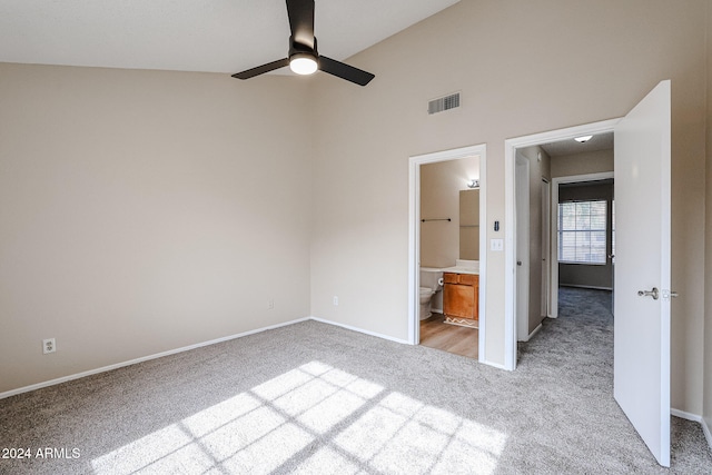 unfurnished bedroom with lofted ceiling, light colored carpet, ceiling fan, and ensuite bathroom