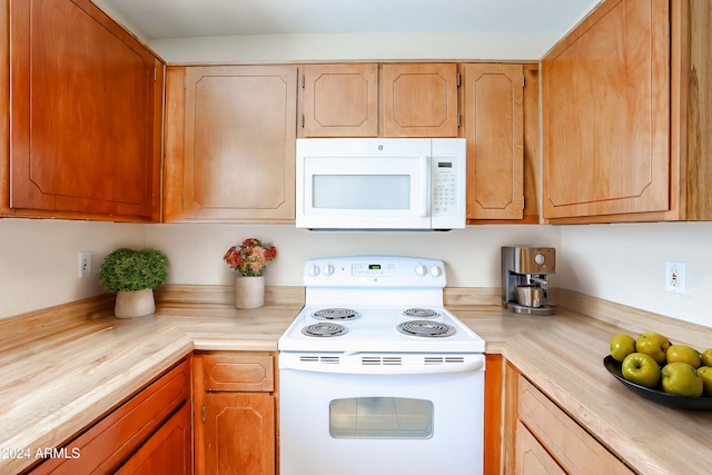 kitchen featuring white appliances and wooden counters