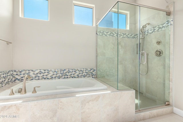 bathroom featuring separate shower and tub