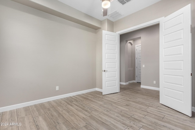 unfurnished bedroom with light hardwood / wood-style floors and ceiling fan