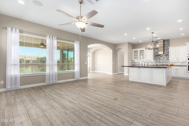 interior space with light hardwood / wood-style floors and ceiling fan