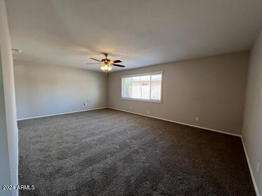 empty room with ceiling fan and carpet