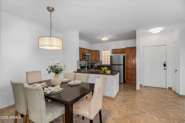 dining room with ornamental molding, light tile patterned flooring, and baseboards