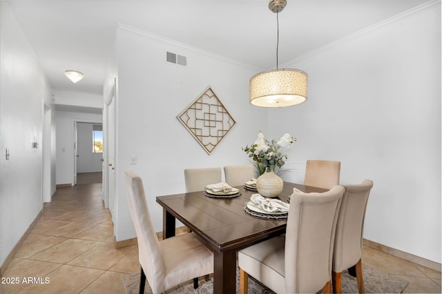 dining space with light tile patterned floors, ornamental molding, visible vents, and baseboards