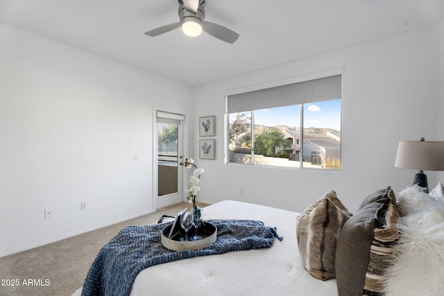 carpeted bedroom with ceiling fan and baseboards