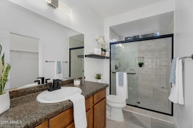 full bathroom featuring toilet, a stall shower, tile patterned flooring, and vanity