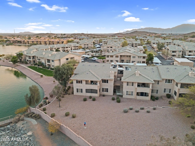 birds eye view of property with a residential view and a water and mountain view