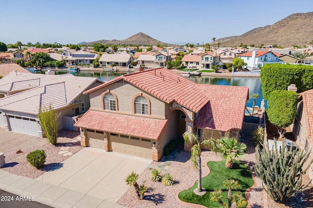 birds eye view of property with a water and mountain view