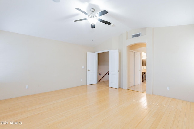 empty room with light hardwood / wood-style flooring, vaulted ceiling, and ceiling fan