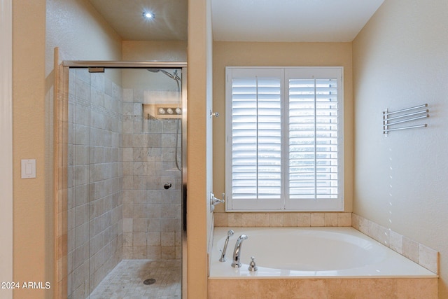 bathroom with separate shower and tub