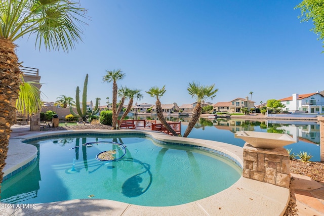 view of pool with a water view