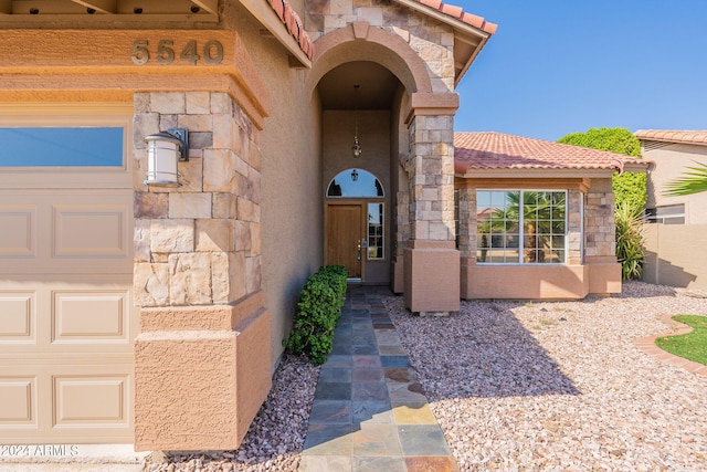 view of exterior entry featuring a garage