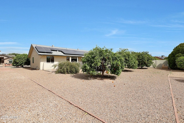 20853 N Gable Hill Dr, Sun City West, AZ 85375 - exterior space featuring roof mounted solar panels and stucco siding
