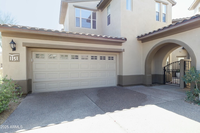 garage featuring a gate and driveway