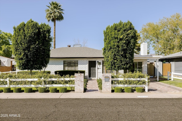 view of front of property featuring fence