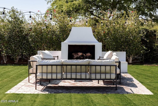 view of patio / terrace with an outdoor living space with a fireplace