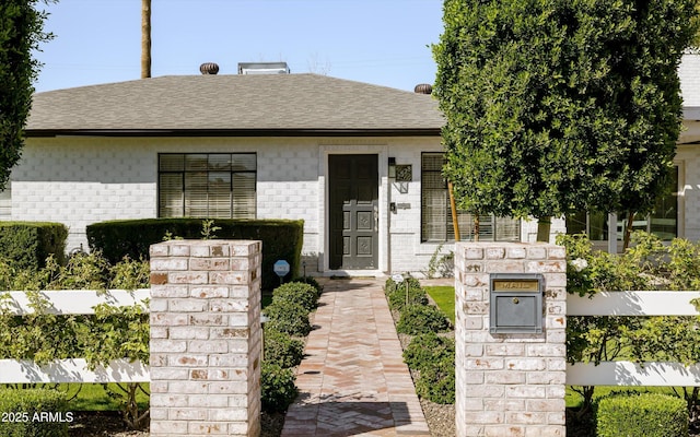 view of front of house with a shingled roof