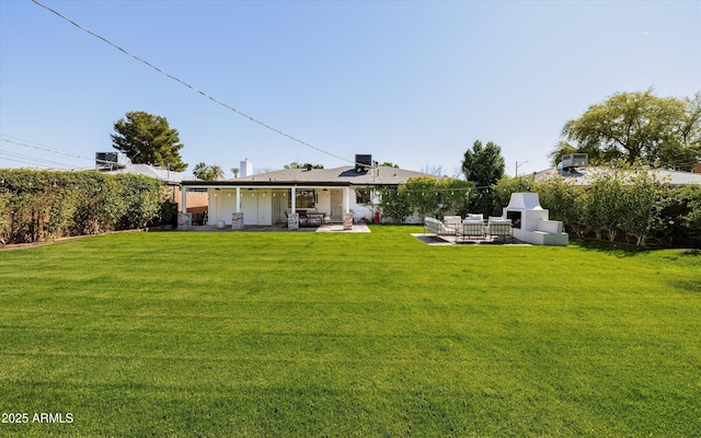 rear view of property with an outdoor hangout area, a patio, and a lawn