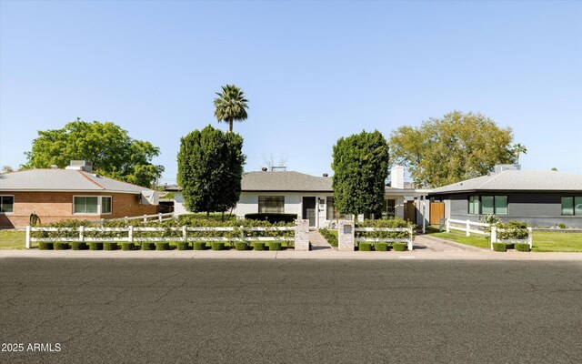 single story home with a fenced front yard