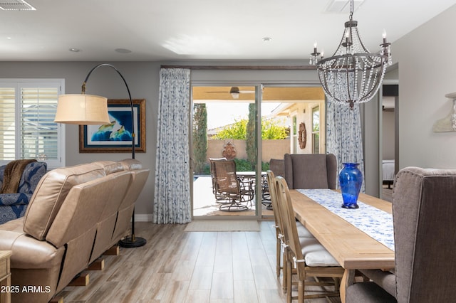 dining space featuring a notable chandelier and light hardwood / wood-style flooring