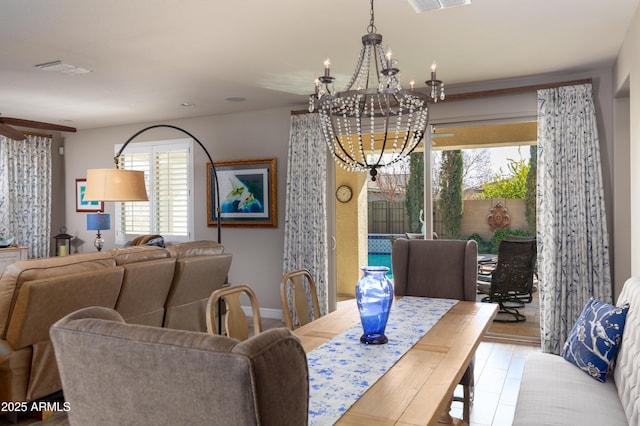 dining area with ceiling fan with notable chandelier