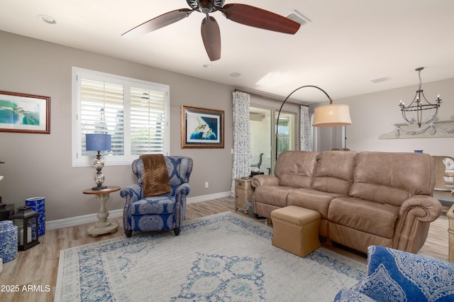 living room featuring ceiling fan and light hardwood / wood-style flooring