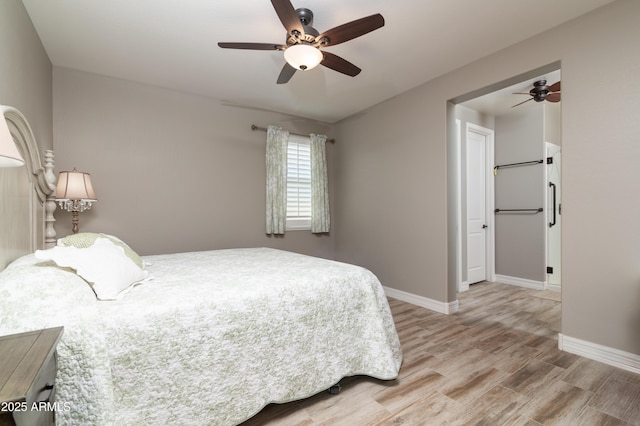 bedroom with ceiling fan and light hardwood / wood-style floors