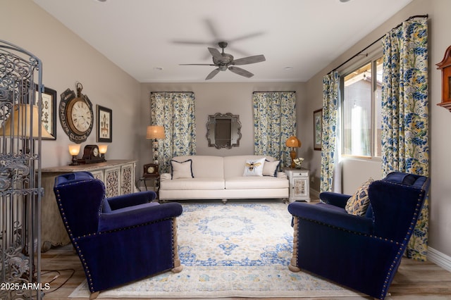 living room with ceiling fan and light wood-type flooring