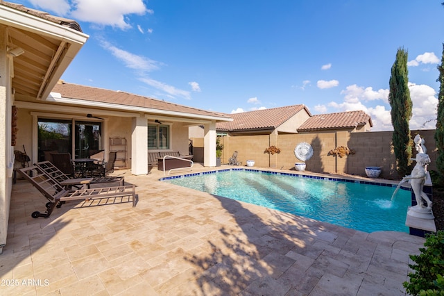 view of pool with pool water feature, ceiling fan, and a patio area